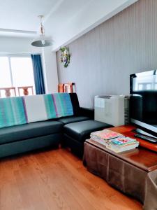 a living room with a black couch and a coffee table at aup178 in Sapporo