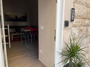 a door leading into a living room with a table at B&B Nadia House in Bisceglie