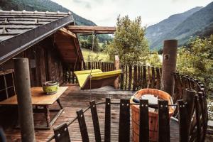 a wooden deck with a hammock on top of a house at Troadkasten - Nationalpark Kalkalpen in Ramsau