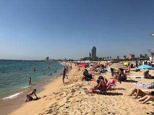 a group of people sitting on a beach at Superflat near beach 15' center in Sant Adria de Besos