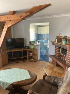a living room with a couch and a table and a kitchen at Agroturystyka Baza in Góralice