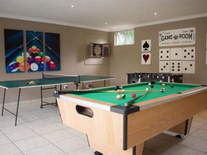 a billiard room with two tables and a pool at Mangrove Beach Estate - 3 Mtwalume in Port Shepstone