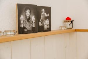 a shelf with three pictures on top of it at Ferienwohnung deine Rauszeit in Seebach