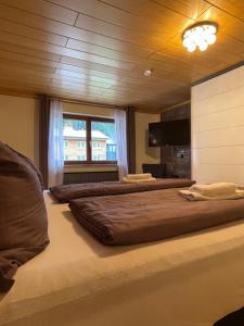 a large bedroom with two beds and a window at Haus St. Martin in Klösterle am Arlberg