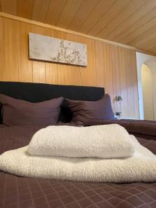 a white blanket on top of a bed at Haus St. Martin in Klösterle am Arlberg