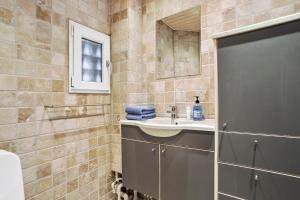 a bathroom with a sink and a mirror at Cozy 2-Bed Apartment in Aalborg in Aalborg