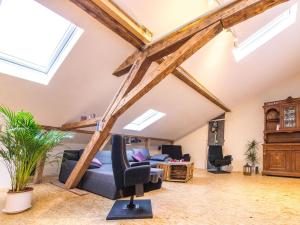 a living room with exposed beams and a blue couch at Loft Sven in Baden-Baden