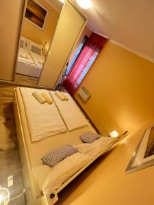 a bedroom with a bed and a mirror at Gold Sea Apartman in Siófok +8 photos