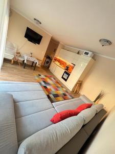 a large couch in a room with a living room at Gold Sea Apartman in Siófok
