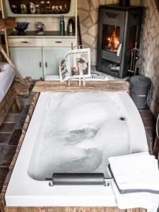 a bath tub in a kitchen with a fireplace at Romantik-Suite - Nationalpark Kalkalpen in Ramsau