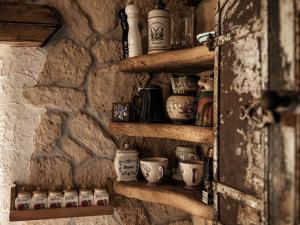 a shelf filled with pottery on a stone wall at Romantik-Suite - Nationalpark Kalkalpen in Ramsau