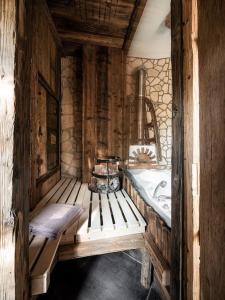 a bathroom with a bench and a sink and a mirror at Romantik-Suite - Nationalpark Kalkalpen in Ramsau