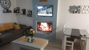 a living room with a couch and a fireplace at Lower Main Street Apartment in Letterkenny