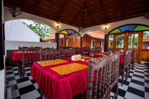 a dining room with tables and chairs in a building at CHETTINAD HERITAGE WELLNESS RESORTS in Mithilaipatti