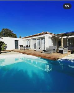 a house with a swimming pool in front of a house at villa ORANANS in Marseillan