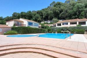 a swimming pool in a yard with houses at Studio Cocoon Hut in Villeneuve-Loubet