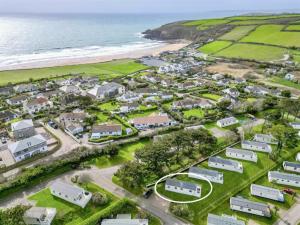 an aerial view of a village next to the ocean at Pottsville Cabin - 2 bed - near Praa Sands Beach in Praa Sands
