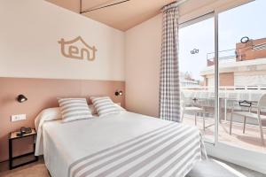 a bedroom with a bed and a large window at tent Lloret de Mar in Lloret de Mar