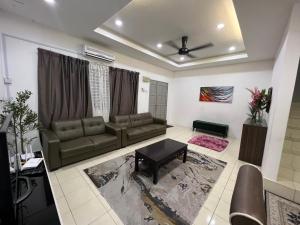 a living room with a couch and a table at RUMAH MURNI by IMPIAN HOMESTAY KLIA-SALAK TINGGI-NILAI in Sepang