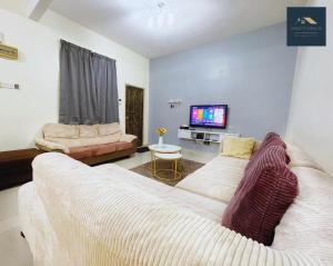 un soggiorno con due divani bianchi e una TV di Sweet Home_30( 15 mins to Jonker Street ) a Malacca