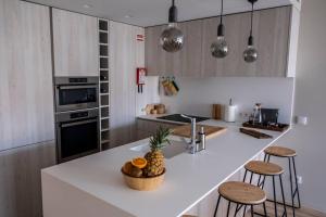 a kitchen with a counter with a pineapple on it at LOCA OFIR Duplex - Entre Rio e Mar in Fão