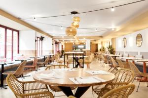 a dining room with tables and chairs and windows at tent Lloret de Mar in Lloret de Mar