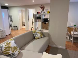 a living room with a couch and a table at apartamento luanco playa in Luanco