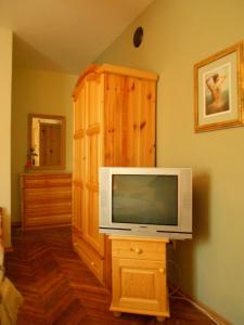 a living room with a tv and a wooden cabinet at Hostel Del Mar in Varna City