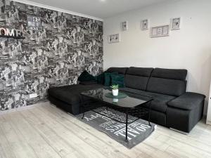 a living room with a couch and a table at Cozy apartment in Jūrmala