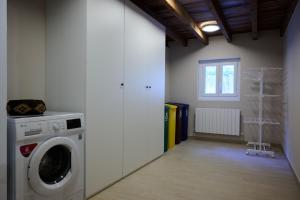 a laundry room with a washing machine and a window at Ojangoiti with outlet for electric vehicle By Kabia Gestión in Gautegiz Arteaga