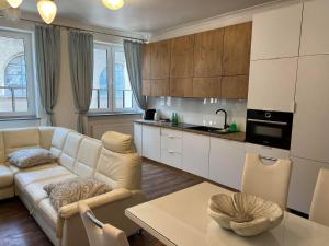 a living room with a couch and a table at Apartamenty pod Katedrą in Bielsko-Biała