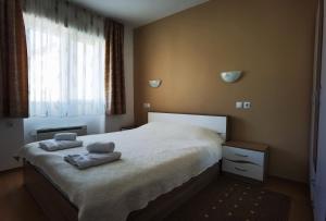 sypialnia z łóżkiem z dwoma ręcznikami w obiekcie Апартамент 204 Студенец w mieście Pamporowo