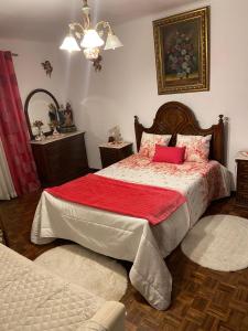 a bedroom with a bed with a red blanket at Cacho D'ouro in Santa Marta de Penaguião