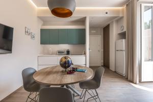 a kitchen and dining room with a wooden table and chairs at Apartment Natale 2 in Monopoli