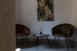 two chairs and a table with a vase on it at Apartment Natale 2 in Monopoli