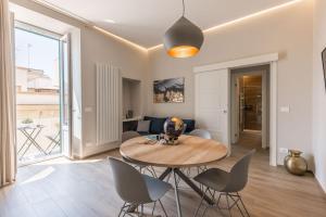 a dining room and living room with a table and chairs at Apartment Natale 2 in Monopoli
