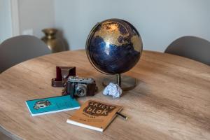 a table with a camera and a globe and a book at Apartment Natale 2 in Monopoli +36 photos