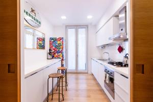 a kitchen with white cabinets and a counter top at Oliveri Vintage House at Politeama in Palermo