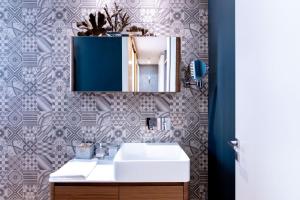 a bathroom with a sink and a mirror at Oliveri Vintage House at Politeama in Palermo +8 photos