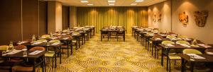 a large room with tables and chairs in it at Garden Court Umhlanga in Durban