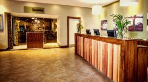 a lobby with a bar in a restaurant at Sabi River Sun Resort in Hazyview