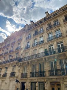 a large building with balconies on the side of it at Paris 8 golden triangle - fancy brand new appt in historic building in Paris