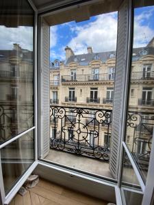 a window with a view of a building at Paris 8 golden triangle - fancy brand new appt in historic building in Paris