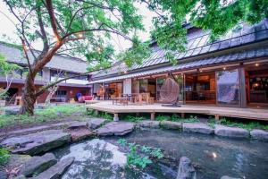 a house with a pond in the yard at Nagano - House - Vacation STAY 14590 in Nagano