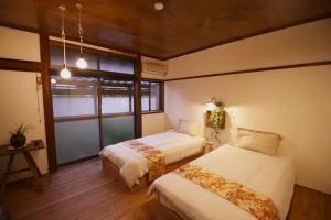 a bedroom with two beds and a window at Nagano - House - Vacation STAY 14590 in Nagano