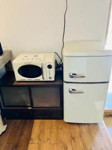 a microwave sitting on a counter next to a refrigerator at Nagano - House - Vacation STAY 14689 in Nagano