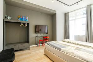 a bedroom with a bed and a flat screen tv at Viral 2 BR Photo Studio Loft in Sofia