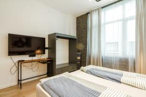 a bedroom with two beds and a flat screen tv at Viral 2 BR Photo Studio Loft in Sofia