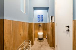 a bathroom with a toilet and wooden walls at Viral 2 BR Photo Studio Loft in Sofia +17 photos