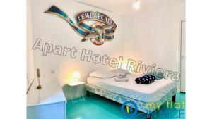 a room with a bed and a sign on the wall at ApartHotel Riviera - Amazing large 3 bedrooms with Sea View AC - Old Town- Promenade des Anglais - SEA VIEW in Nice